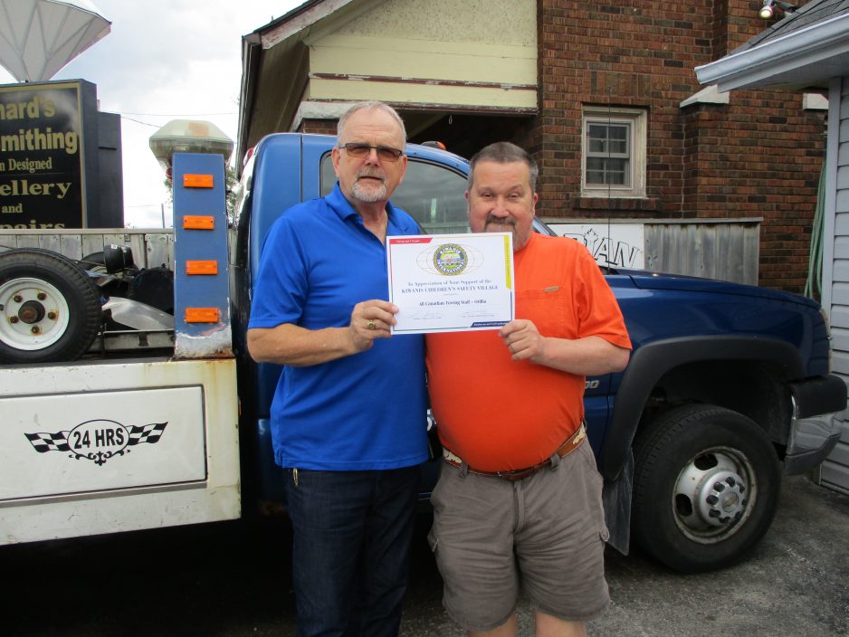Gerry Dwyer retired OPP Constable presenting Alan Carr, head dispatcher at All Canadian Towing